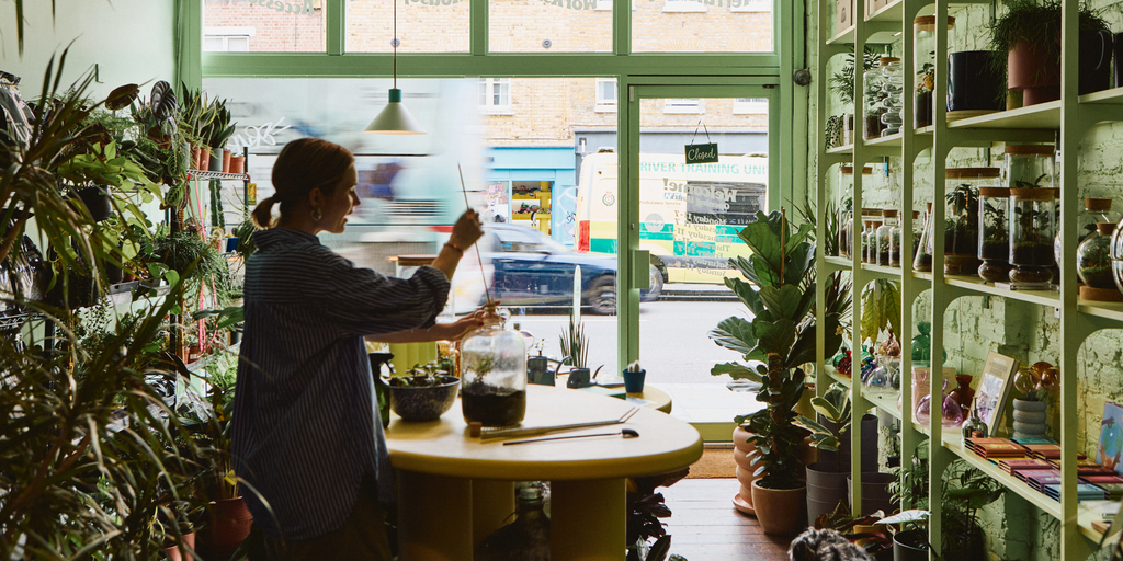 Emma Sibley planting a glass terrarium in her Shoreditch store